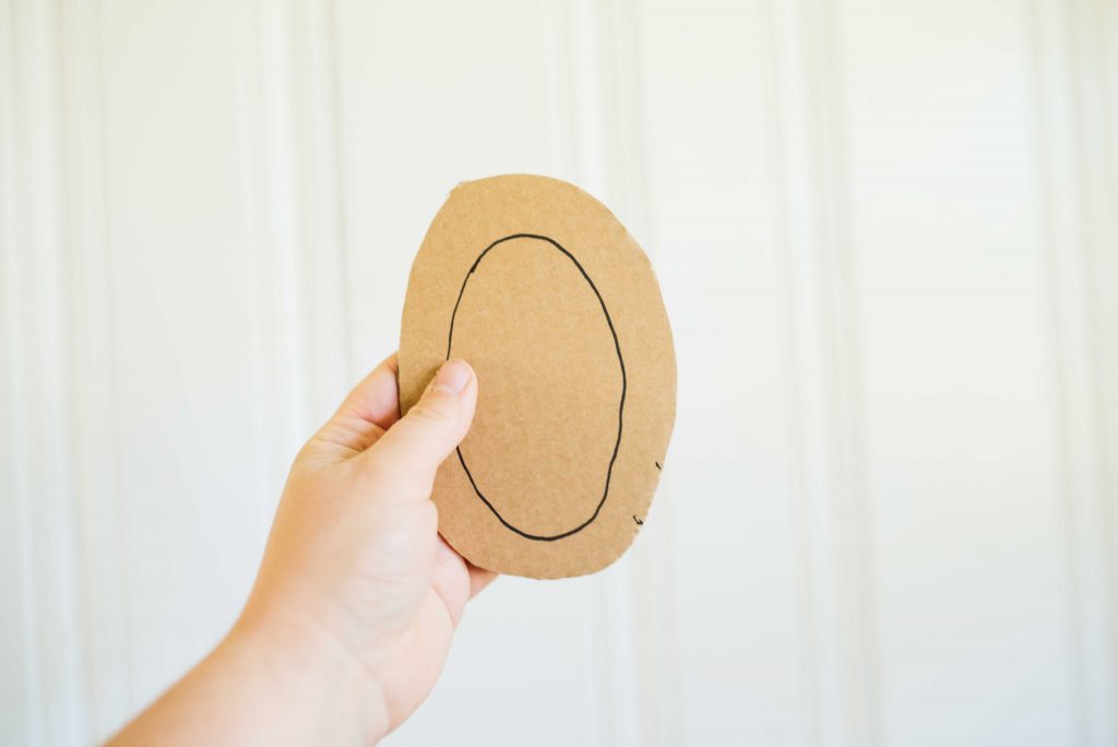 an oval shaped cardboard piece with a sharpie oval drawn on it