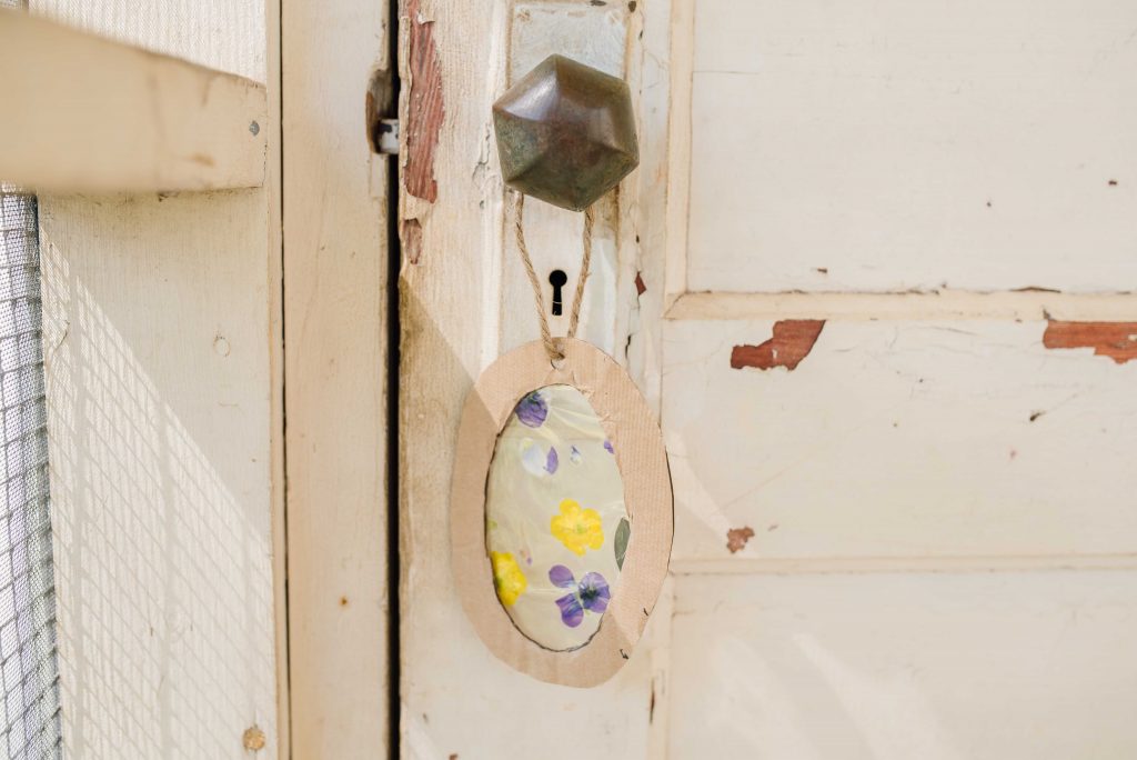 a suncatcher hung on an antique doorknob